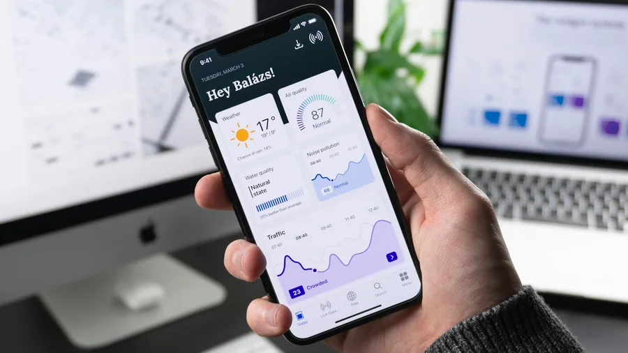 Hands holding a smartphone for a wellness brand mobile experience